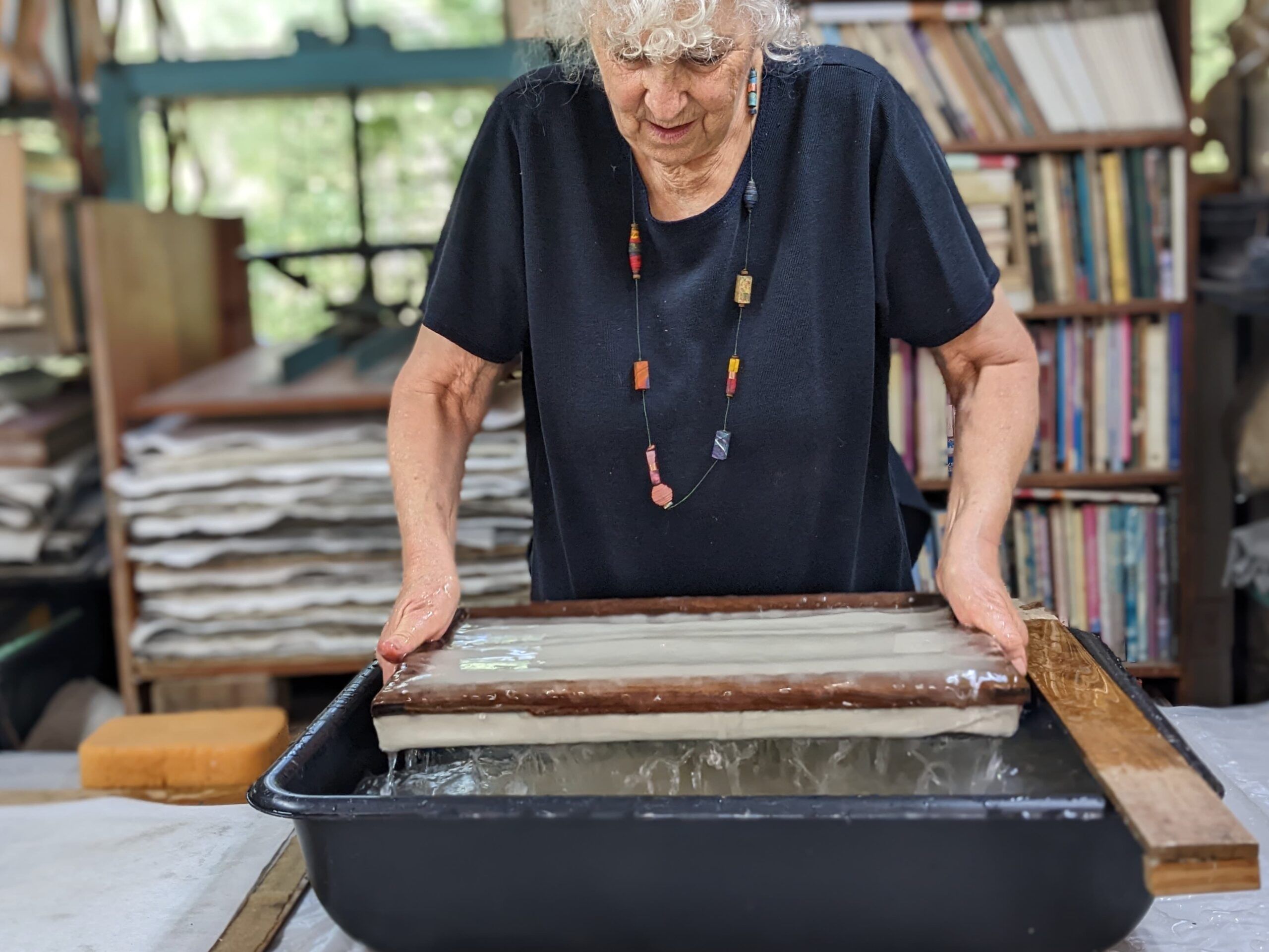 Claudia Lee demonstrating paper making in her private, working studio. 